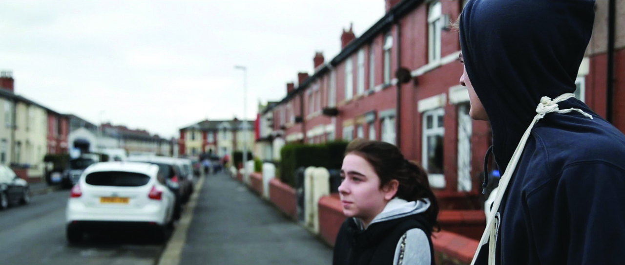 Two teenagers on an urban street